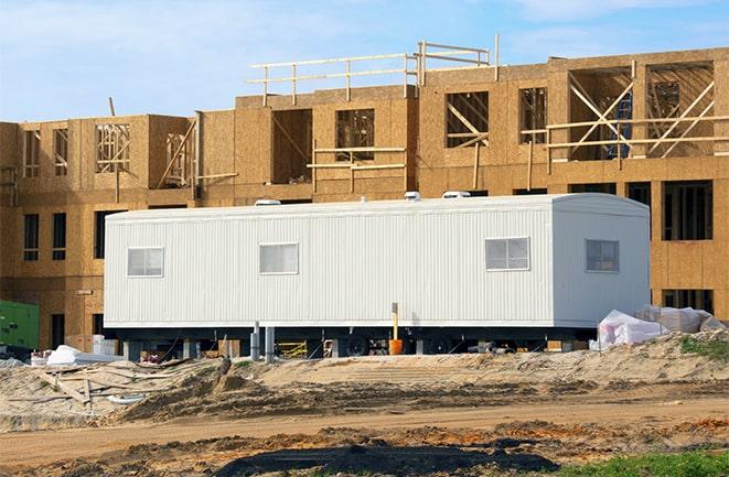 crane lifting modular building for construction office rentals in Forest View